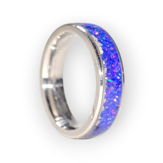 Looking for a unique and stunning piece of jewelry? Feast your eyes on this exquisite, handmade ring! Crafted with a mesmerizing stardust blue opal, each ring is a one-of-a-kind work of art. The vibrant play of color within the opal is simply captivating, reminiscent of a distant galaxy.

Set on a durable and comfortable stainless steel band, this ring is perfect for everyday wear. The smooth, polished finish ensures a comfortable fit, while the stainless steel resists tarnishing, keeping your ring looking 
